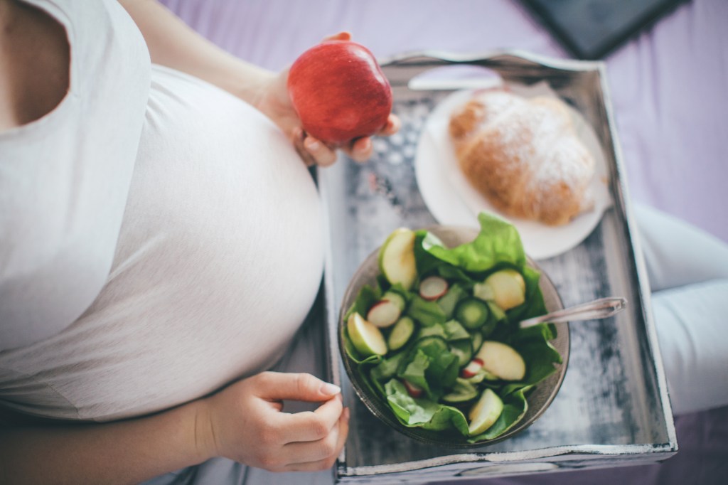 Healthy lunch in bed for pregnant woman