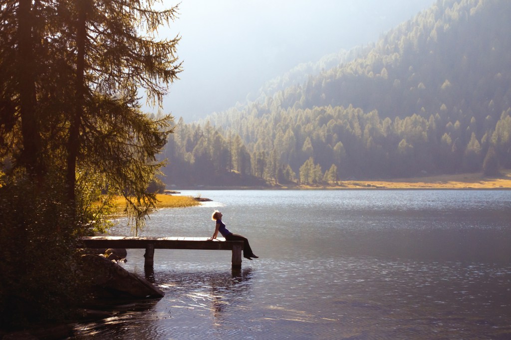 Young woman enjoying nature by a lake